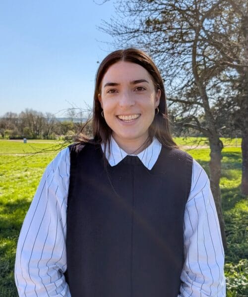 Portrait style photo of Kristen with countryside backdrop