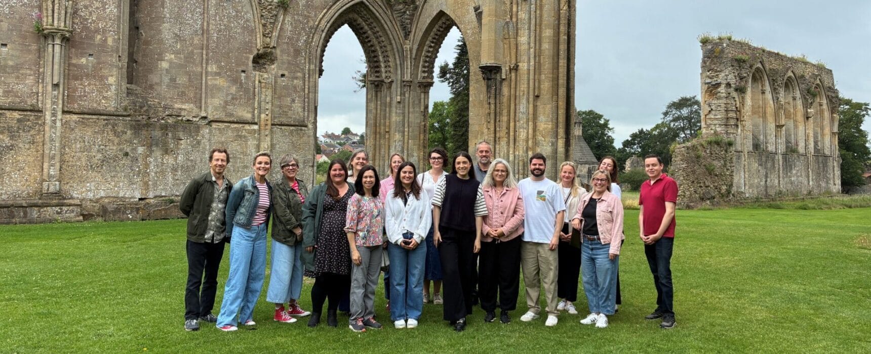 Team pic stood with Glastonbury Abbey ruins behind